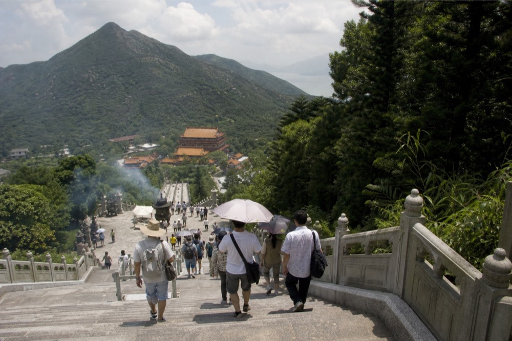Tian Tan Buddha with visitors climbing the steps, no text, no logos, no people