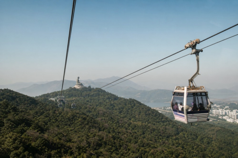 Cable car cabin over Lantau Island with the Big Buddha in the distance, no text, no logos, no people