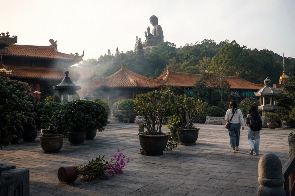 The Tian Tan Buddha statue rising above Po Lin Monastery rooftops, no text, no logos, no people