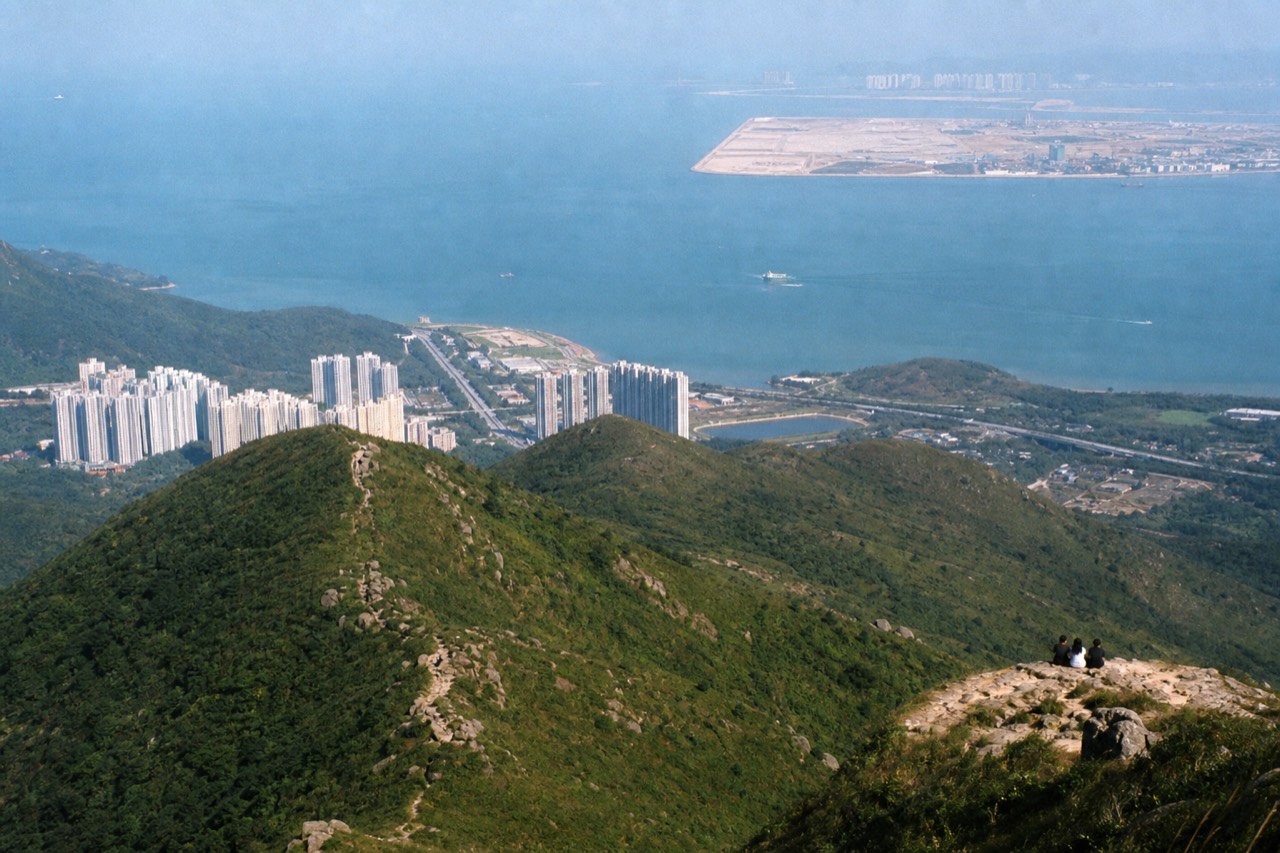 Aerial view of Lantau Island's green mountains and coastline, no text, no logos, no people