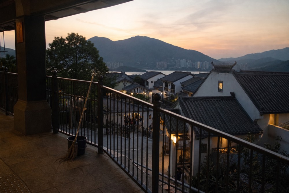 Ngong Ping Village walkways and rooftops below the cable car terminal, no text, no logos, no people