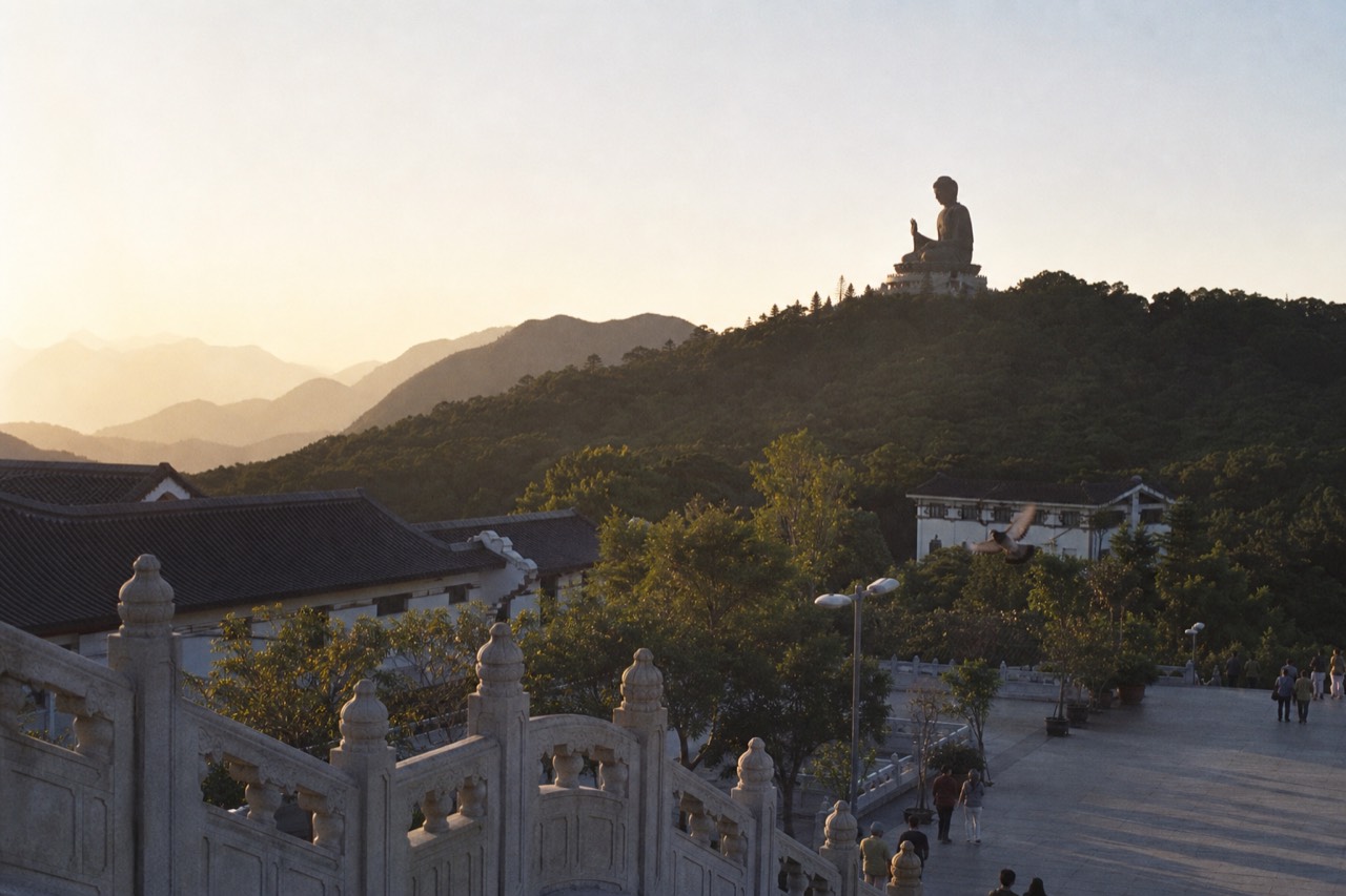 The Tian Tan Buddha seated on a Lantau hilltop above the Ngong Ping plateau, no text, no logos, no people