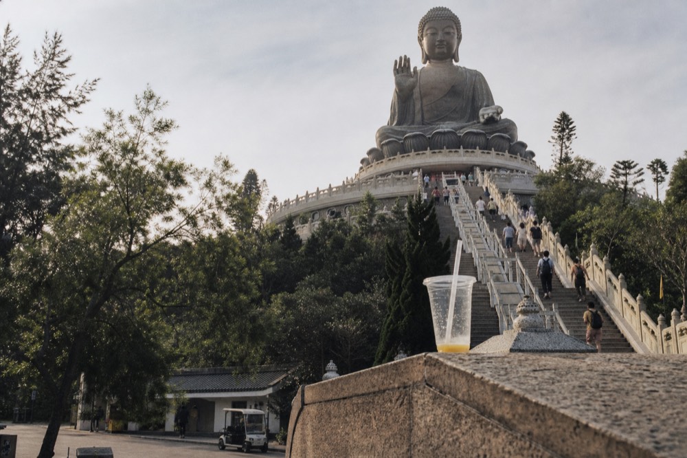 Visitors' viewpoint at the base of the Tian Tan Buddha with the lotus throne visible above, no text, no logos, no people