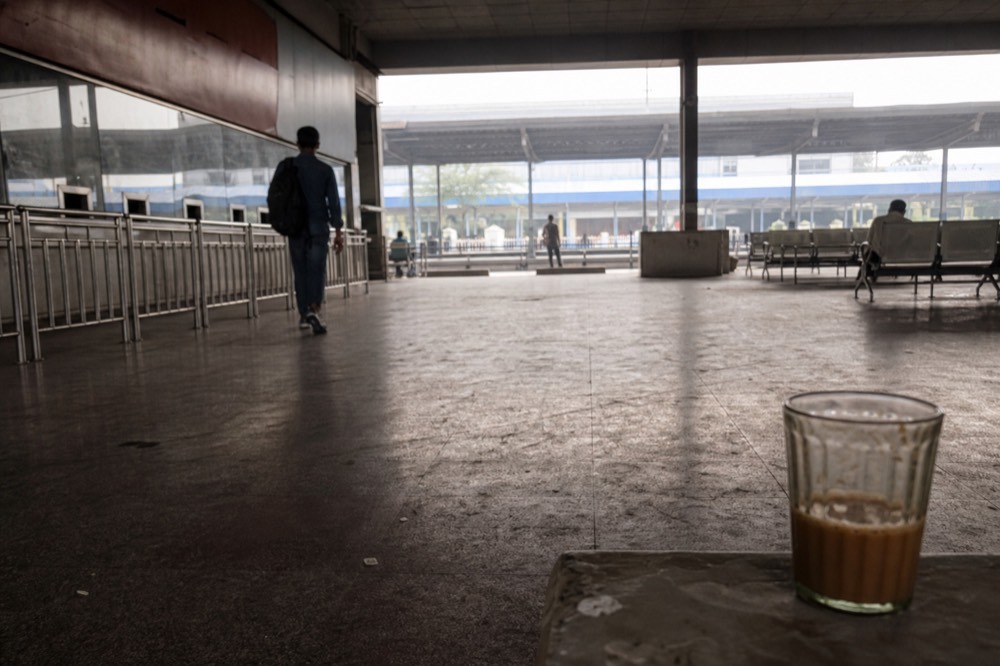 A cable car terminal ticket hall with fare information boards and boarding platforms, no text, no logos, no people.