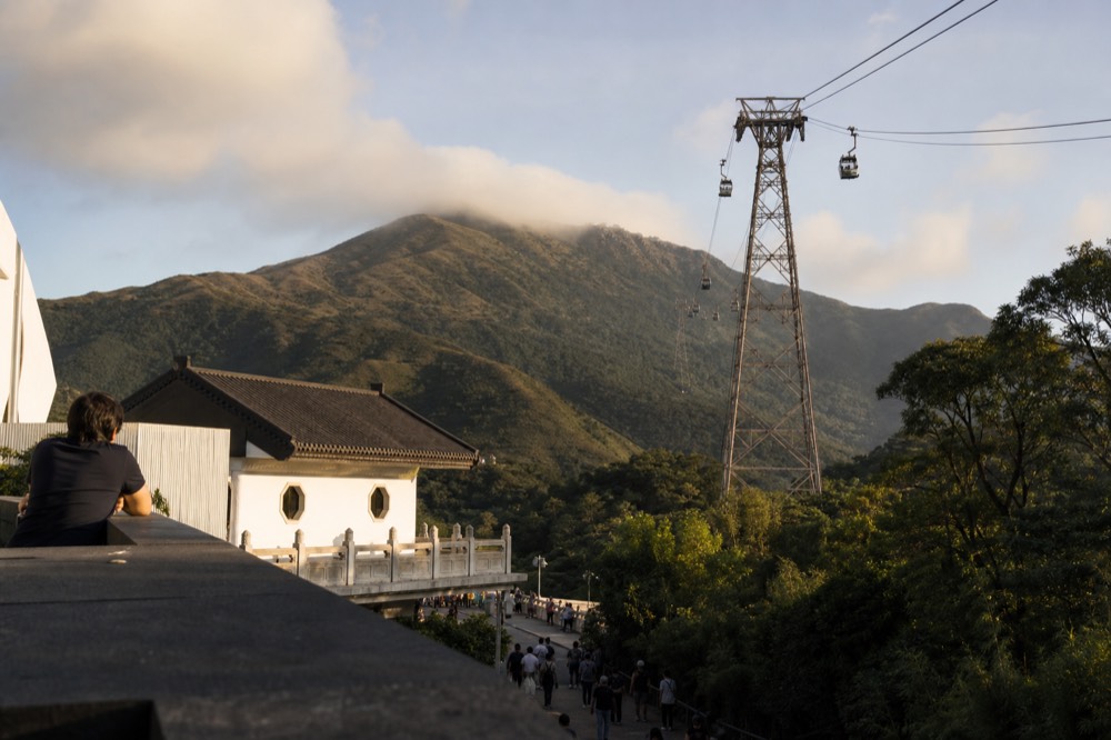 Ngong Ping cable car cabins over the Lantau landscape, no text, no logos, no people