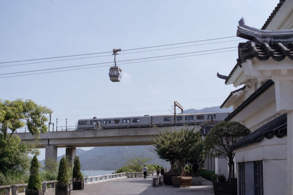 MTR train and cable car cabin side by side, no text, no logos, no people