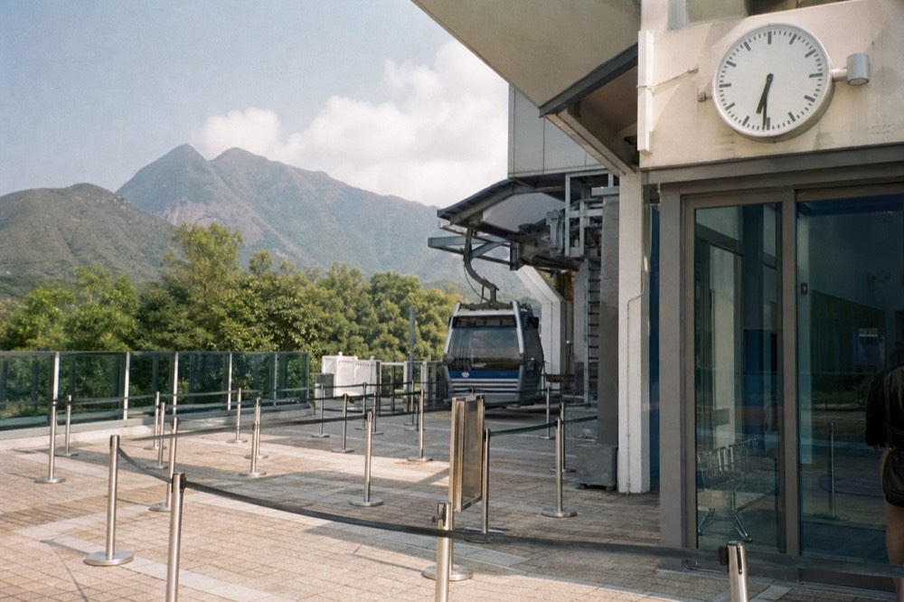 Clock showing 2:30 PM next to cable car terminal entrance, no text, no logos, no people