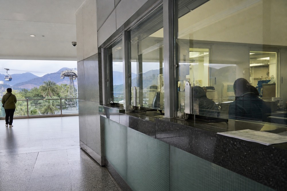 Cable car ticket office counters inside the Tung Chung terminal, no text, no logos, no people