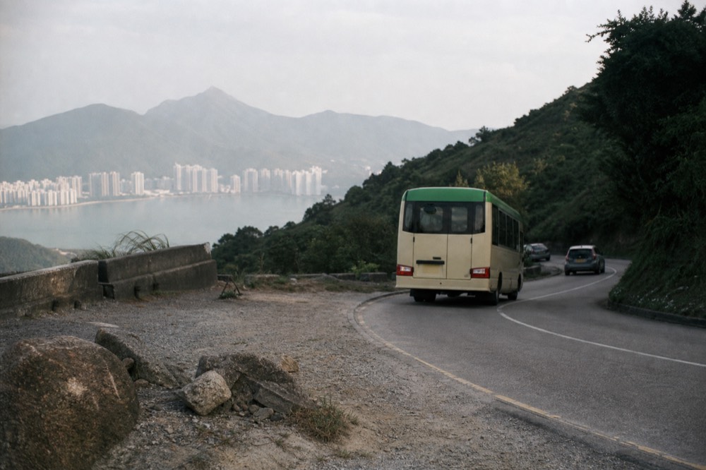 A New Lantao bus on the winding road above Tung Chung, no text, no logos, no people