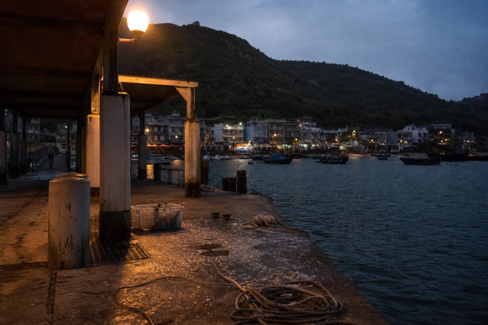 Ferry pier and calm bay at a small island town at dusk, no text, no logos, no people
