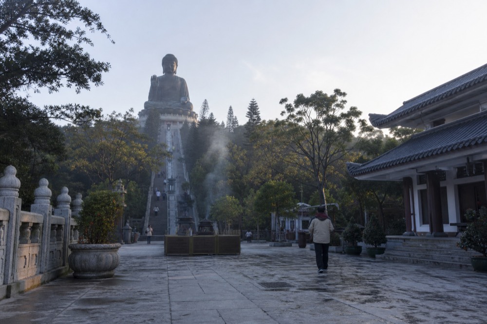 The Tian Tan Buddha statue seen from the approach plaza on the Ngong Ping plateau, no text, no logos, no people.