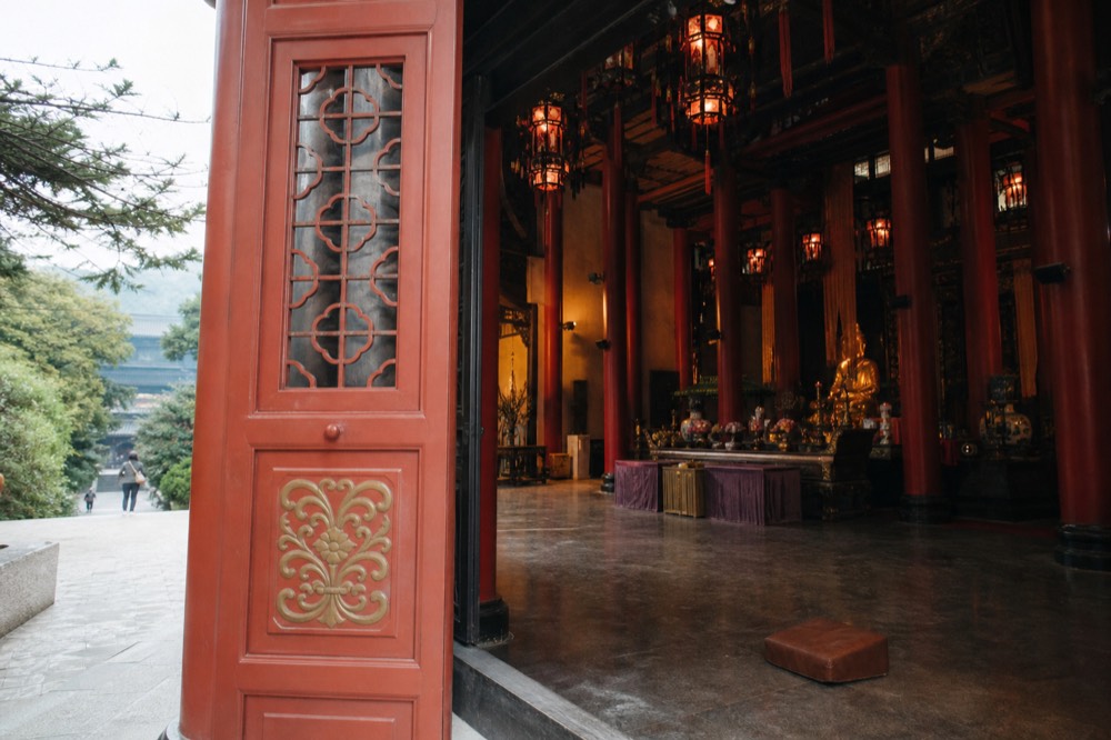 Main shrine hall of Po Lin Monastery with red pillars and lanterns, no text, no logos, no people