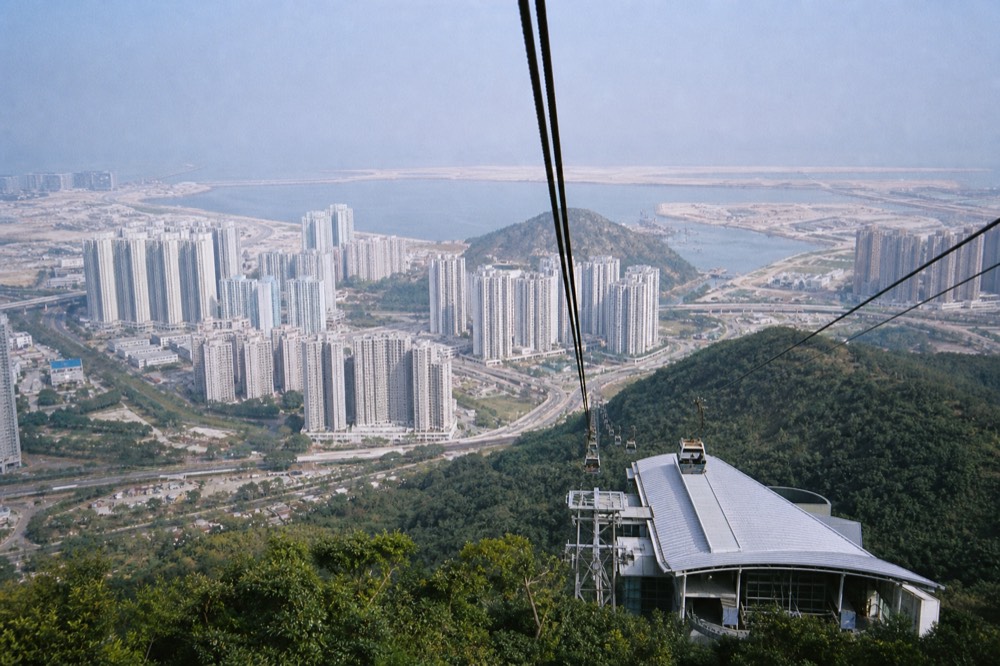 Aerial view of Tung Chung town, Lantau Island, with the cable car terminal and high-rise buildings, no text, no logos, no people