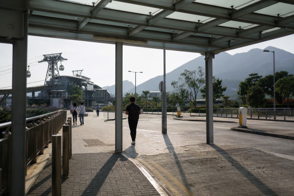 MTR Tung Chung Station Exit B with signs pointing to the Ngong Ping 360 cable car terminal, no text, no logos, no people