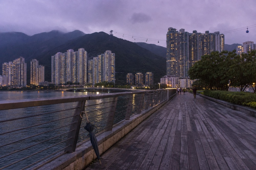 Tung Chung waterfront with hotel buildings and the cable car in the distance, no text, no logos, no people